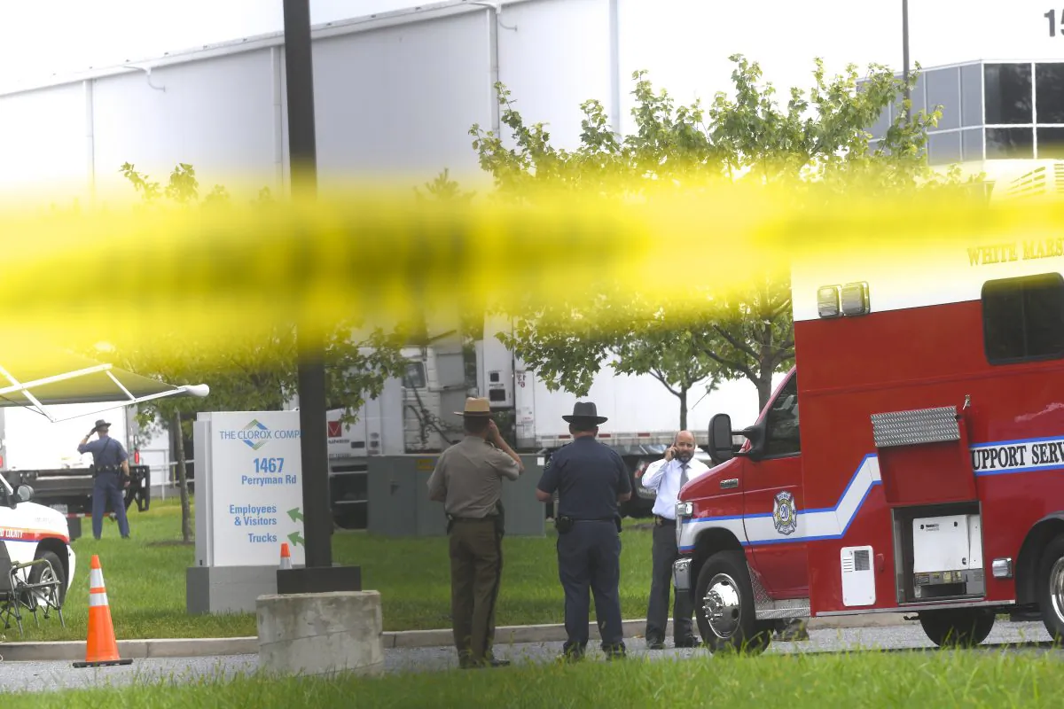 Police officers gather below crime scene tape in front of a Rite Aid Distribution Center where multiple people were killed and injured in a shooting on Sept. 20, 2018 in Aberdeen, Maryland. (Mark Makela/Getty Images)