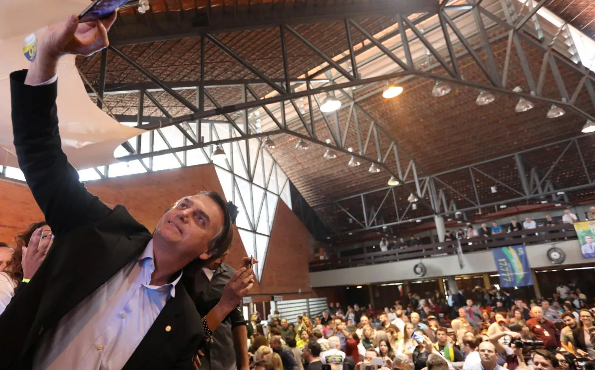 Presidential candidate Jair Bolsonaro takes a selfie as he attends a rallyin Porto Alegre, Brazil Aug. 30, 2018. (Diego Vara/Reuters)