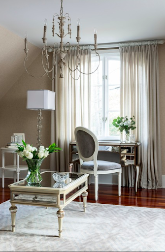 The Amelie Mirrored Console and a mirrored coffee table showcase his preference for art deco, while the vintage French side chair fulfills her love for the classics.