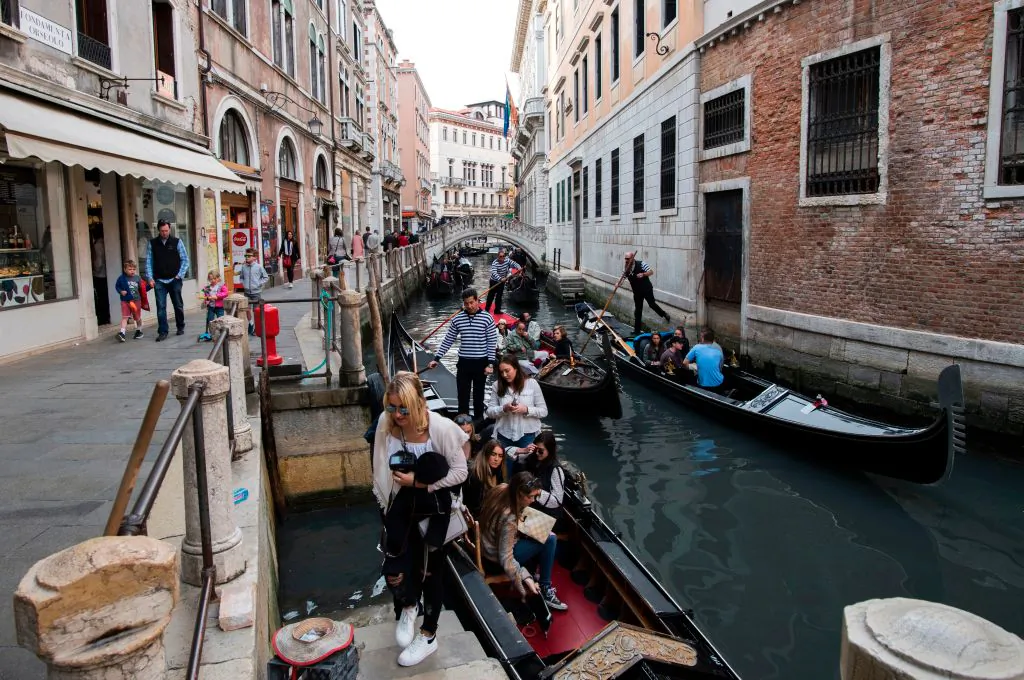 Tourists leave after a tour on a canal in Venice on April 7, 2017. (Miguel Medina/AFP/Getty Images)