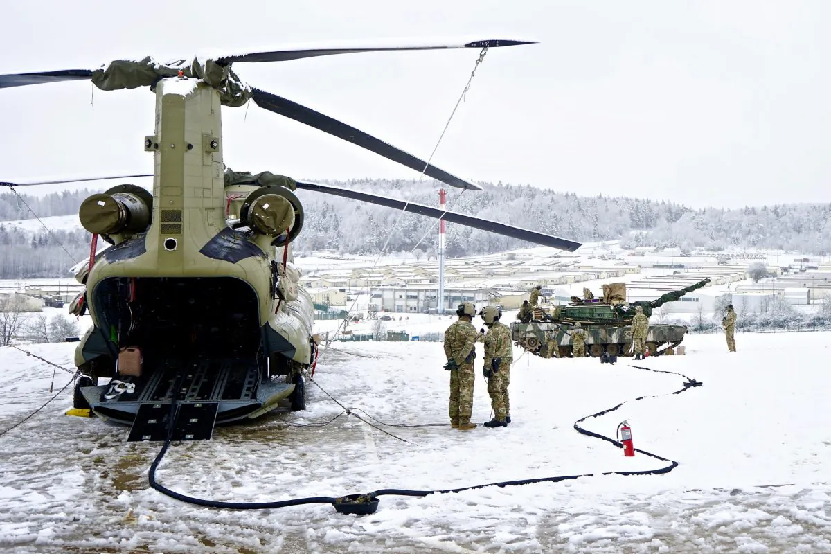 U.S. Army Soldiers work together to refuel an M1 Abrams tank during a simulated jump forward area refueling point exercise at the Hohenfels Training Area, Germany, Jan. 21, 2018. (U.S. Army photo by Sgt. Gregory T. Summers)
