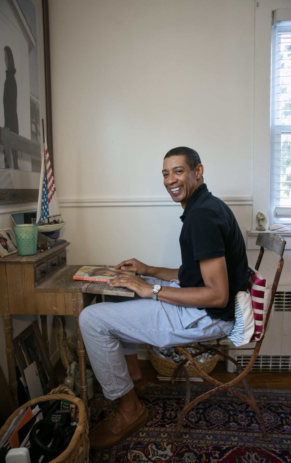 Mario A. Robinson sits at his drawing desk in his studio in Point Pleasant, New Jersey on September 4, 2018. (Milene Fernandez/The Epoch Times)