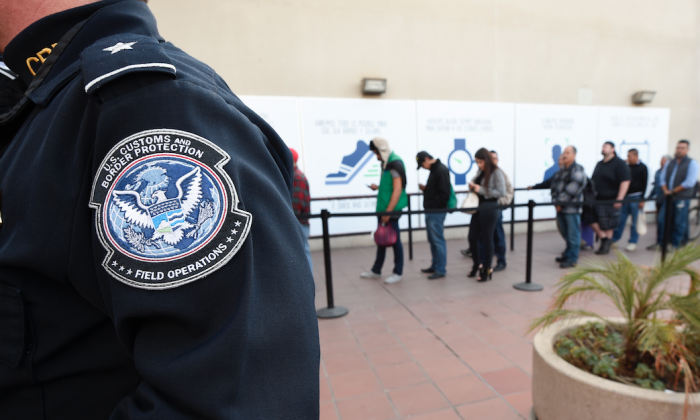 Pedestrians crossing from Mexico into the United States at the Otay Mesa Port of Entry wait in line in San Diego on Dec. 10, 2015. (By Denis Poroy/AP)