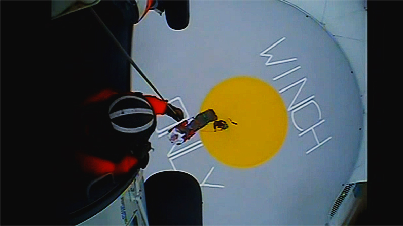 A Coast Guard helicopter crew hoists a sick passenger off the Norwegian Escape