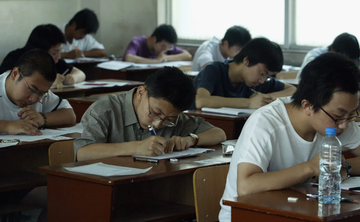Students take part in the college entrance exam at an exam room in a middle school in Xi'an City, Shaanxi Province, China, on June 7, 2005. (China Photos/Getty Images)