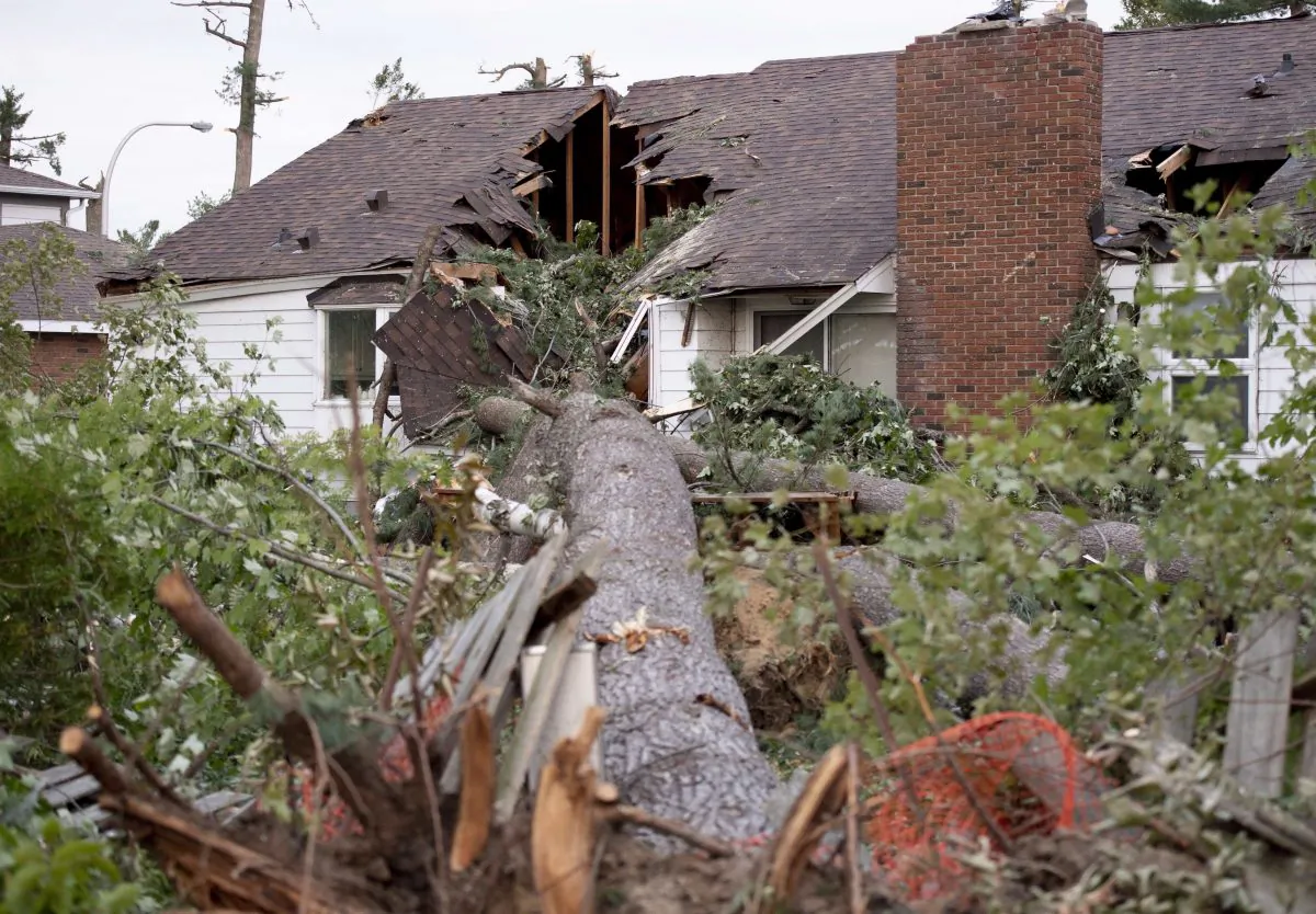 A home suffered severe damage where a tree fell into it during a tornado in the Arlington Woods neighbourhood of Ottawa, on Sept. 23, 2018. (The Canadian Press/Justin Tang)