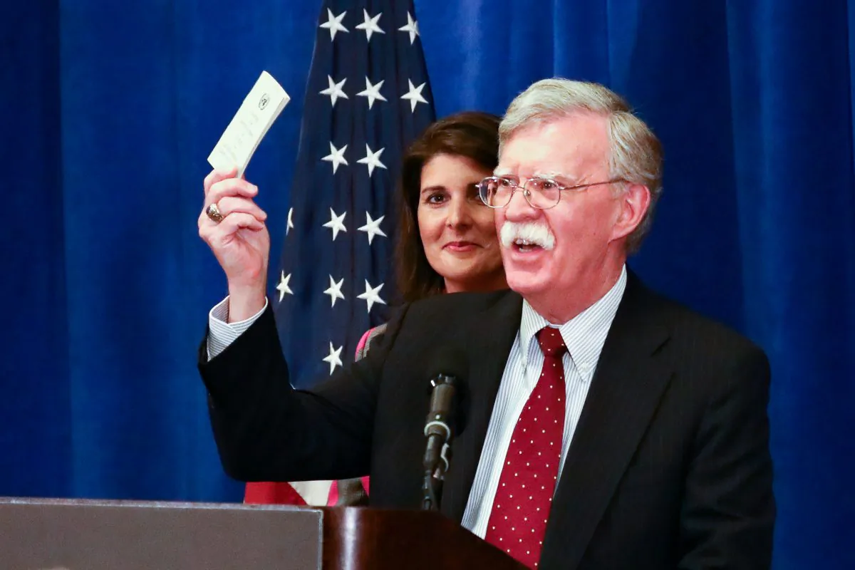 National Security Advisor John Bolton holds up a copy of the Constitution as United States Ambassador to the UN Nikki Haley looks on during a press conference before the UN General Assembly in New York City on Sept. 24, 2018. (Charlotte Cuthbertson/The Epoch Times)