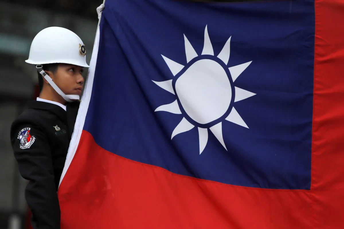A military honor guard holds the Taiwanese national flag at a flag-raising ceremony at the Chiang Kai-shek Memorial Hall in Taipei on March 16, 2018. (Tyrone Siu/Reuters)