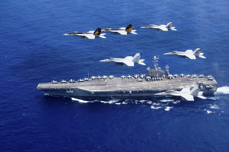 A combined formation of aircraft from Carrier Air Wing (CVW) 5 and Carrier Air Wing (CVW) 9 pass in formation above the Nimitz-class aircraft carrier USS John C. Stennis (CVN 74) in the Philippine Sea on June 18, 2016. (Steve Smith/U.S. Navy/Handout via Reuters)
