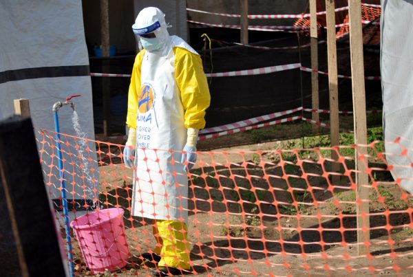 A medical worker wears a protective suit as he prepares to administer ebola patient care