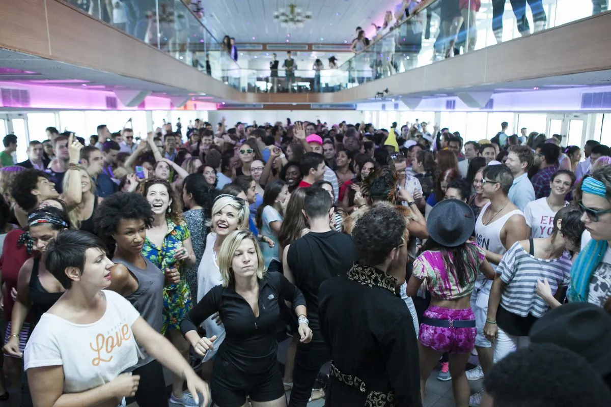 People take part in the Daybreaker dance party on a boat in the morning before going to work in New York,  August 6, 2014. (Samira Bouaou/Epoch Times)