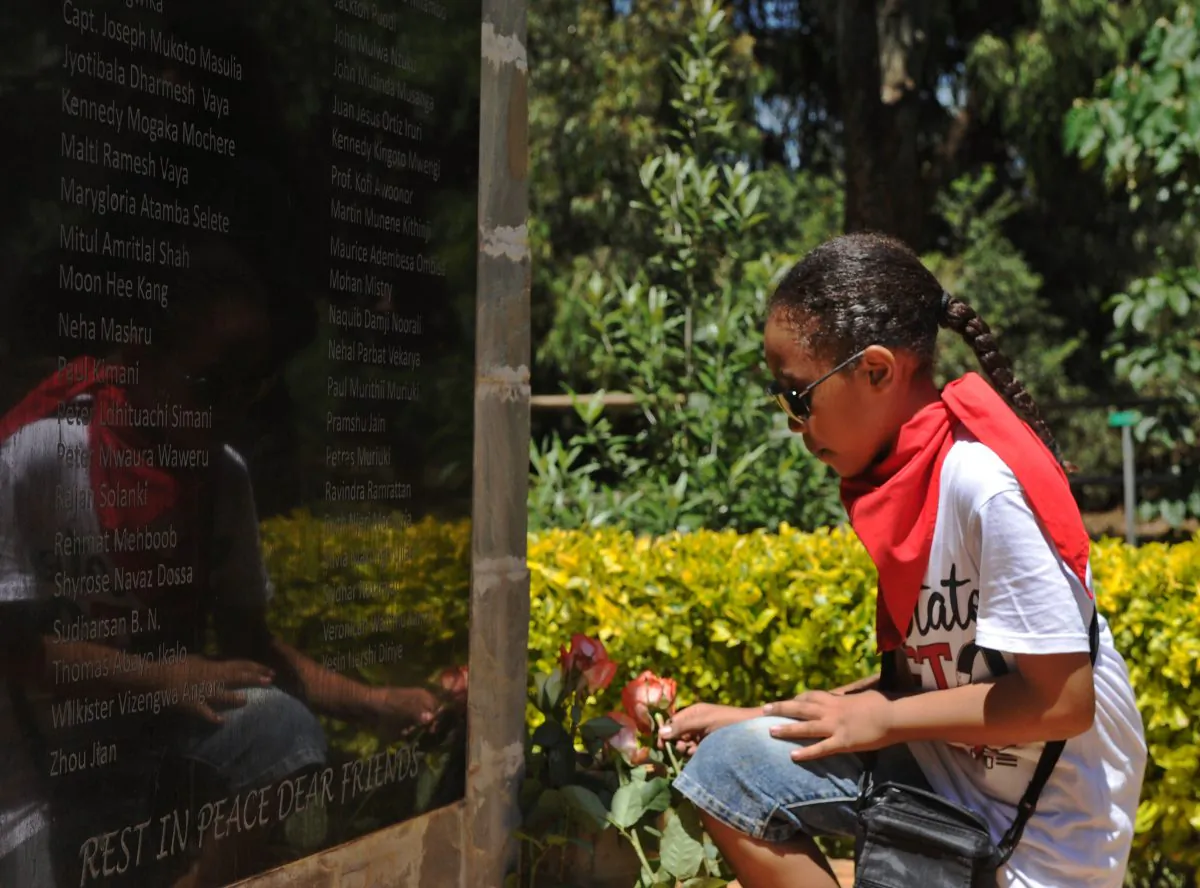 A young girl lays a rose at a memorial stone for the victims of the 2013 al-Shabaab attack on Westgate shopping mall in the Kenyan capital Nairobi on Sept. 20, 2015. (Tony Karumba/AFP/Getty Images)