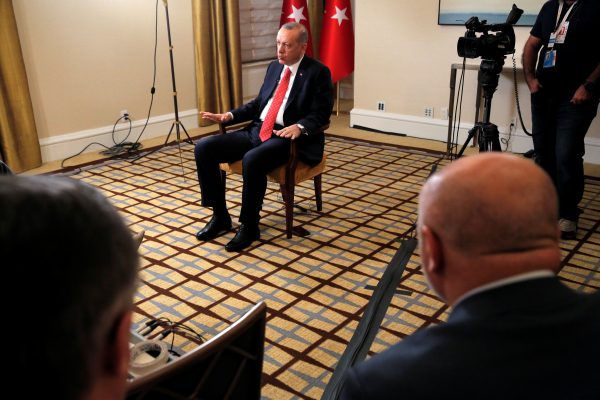 Turkish President Tayyip Erdogan sits during an interview