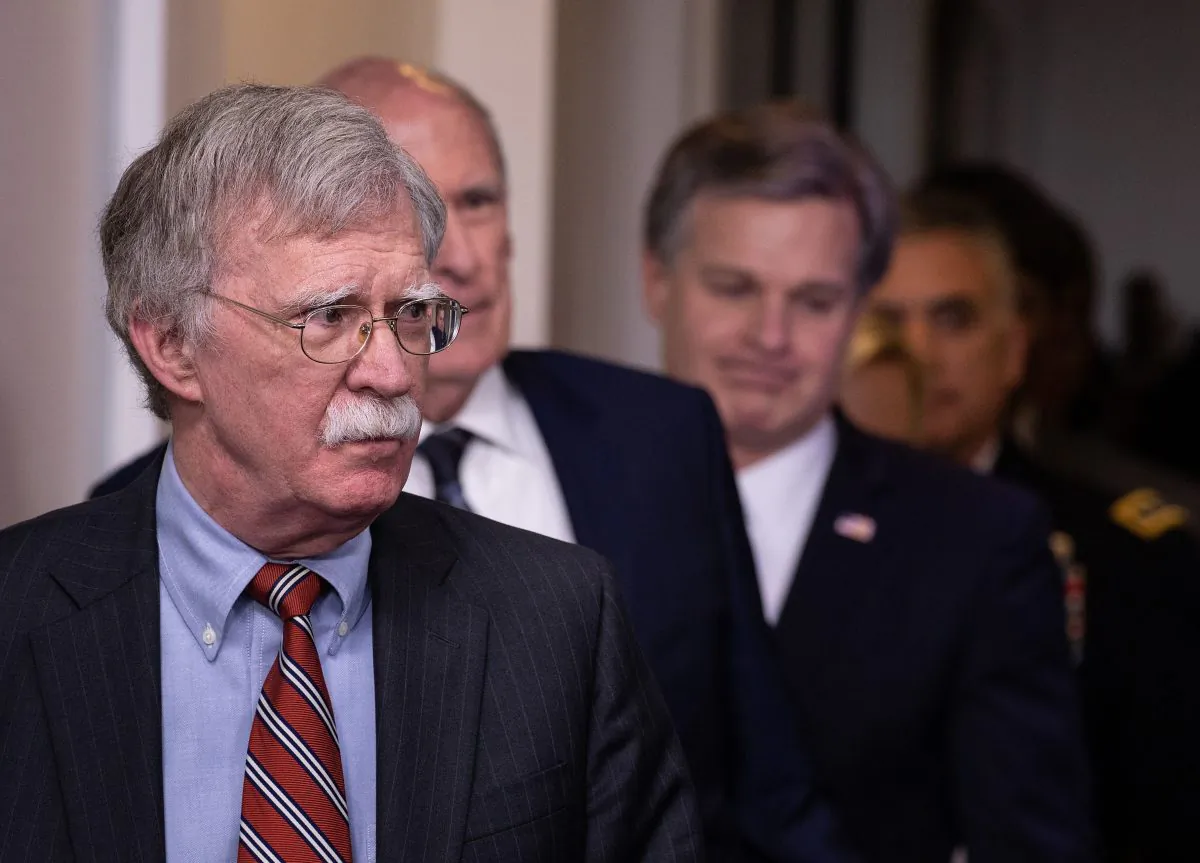 U.S. National Security Advisor John Bolton (L), followed by National Director of Intelligence Dan Coats, FBI Director Christopher Wray, and Commander of the US Cyber Command Gen. Paul Nakasone, arrive for the press briefing at the White House in Washington on Aug. 2, 2018. On Sept. 20, Bolton announced a new U.S. national cyber strategy. (NICHOLAS KAMM/AFP/Getty Images)