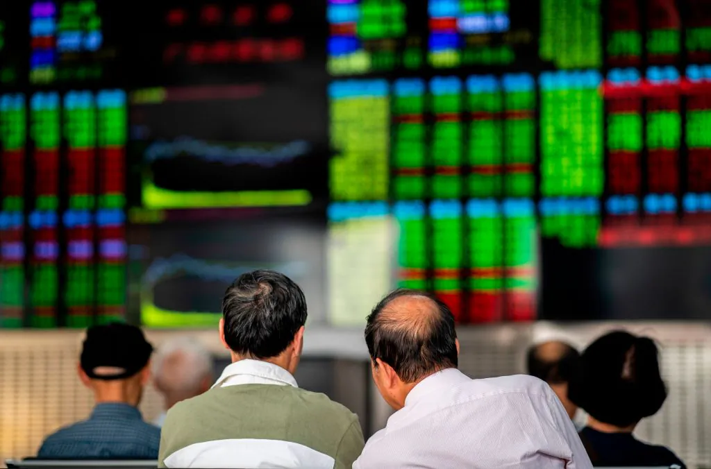 Investors monitor stock prices at a securities company in Shanghai on Sept. 25, 2018. (Johannes Eisele/AFP/Getty Images)