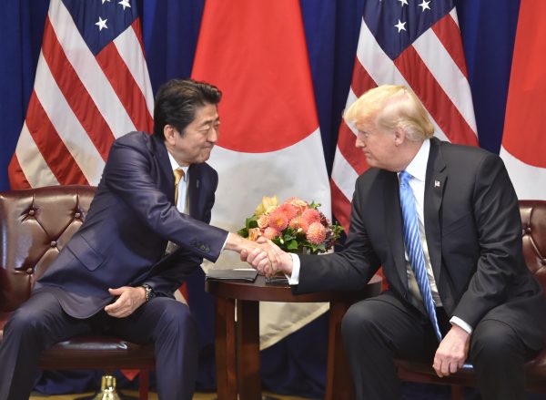 Japanese Prime Minister Shinzo Abe (L) meets with US President Donald Trump