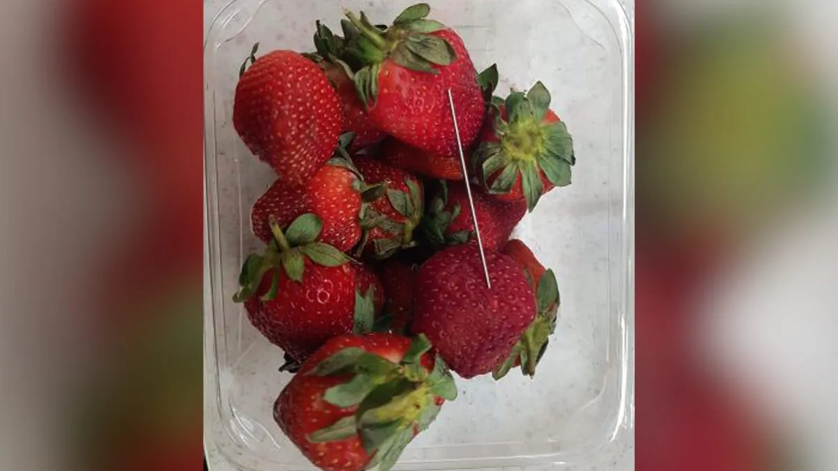 A thin piece of metal seen among a punnet of strawberries in Gladstone, on Sept. 14, 2018. (Queensland Police/AAP/Reuters)