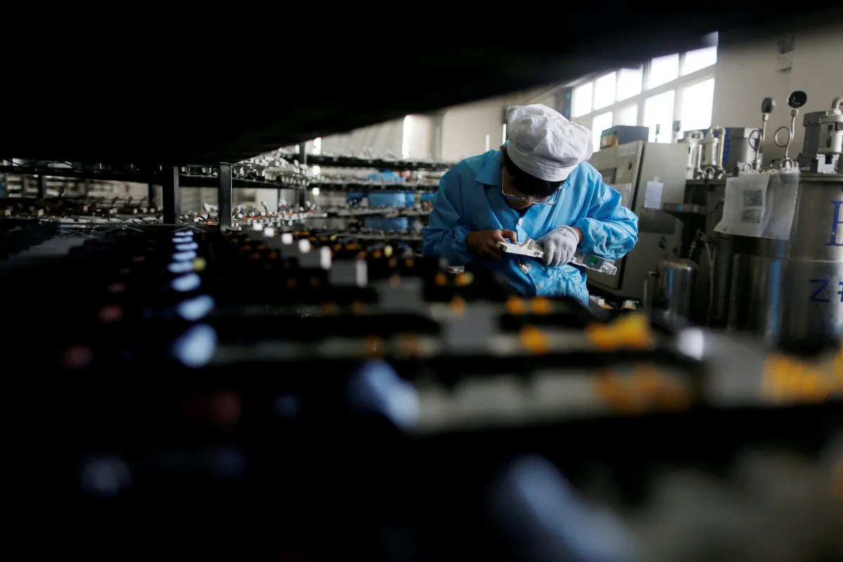 A laborer works inside an electronics factory in Qingdao, Shandong Province, China on January 29, 2018. (William Hong/Reuters)