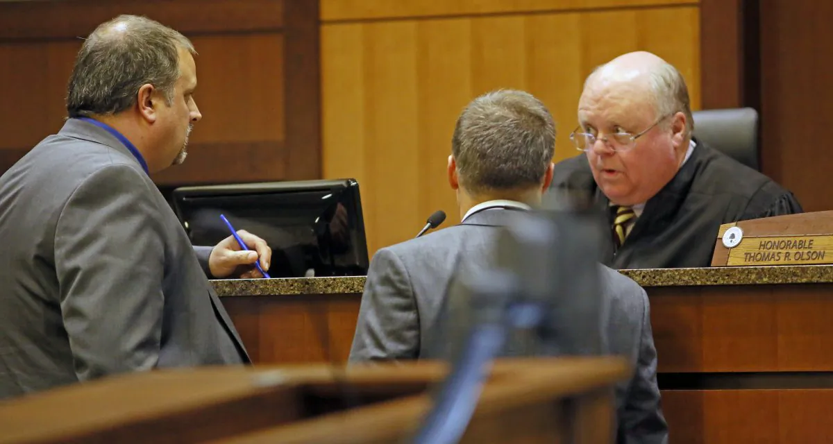 Defense attorney Daniel Borgen, left, and prosecutor Ryan Youngren confer with Judge Thomas Olson in Cass County District Court in Fargo, N.D., during the trial of William Hoehn on Sept. 26, 2018. (David Samson/The Forum via AP)