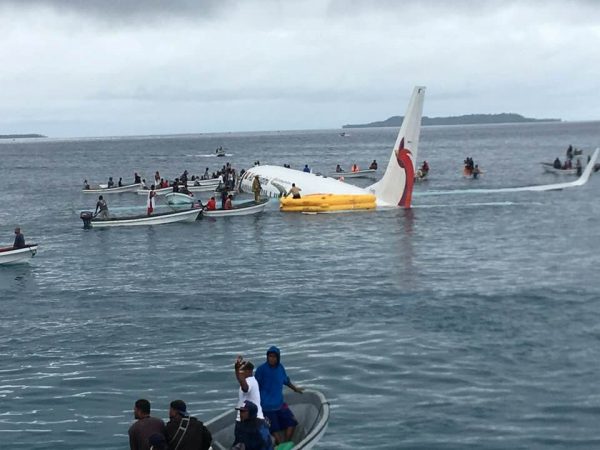 People are evacuated from an Air Niugini plane