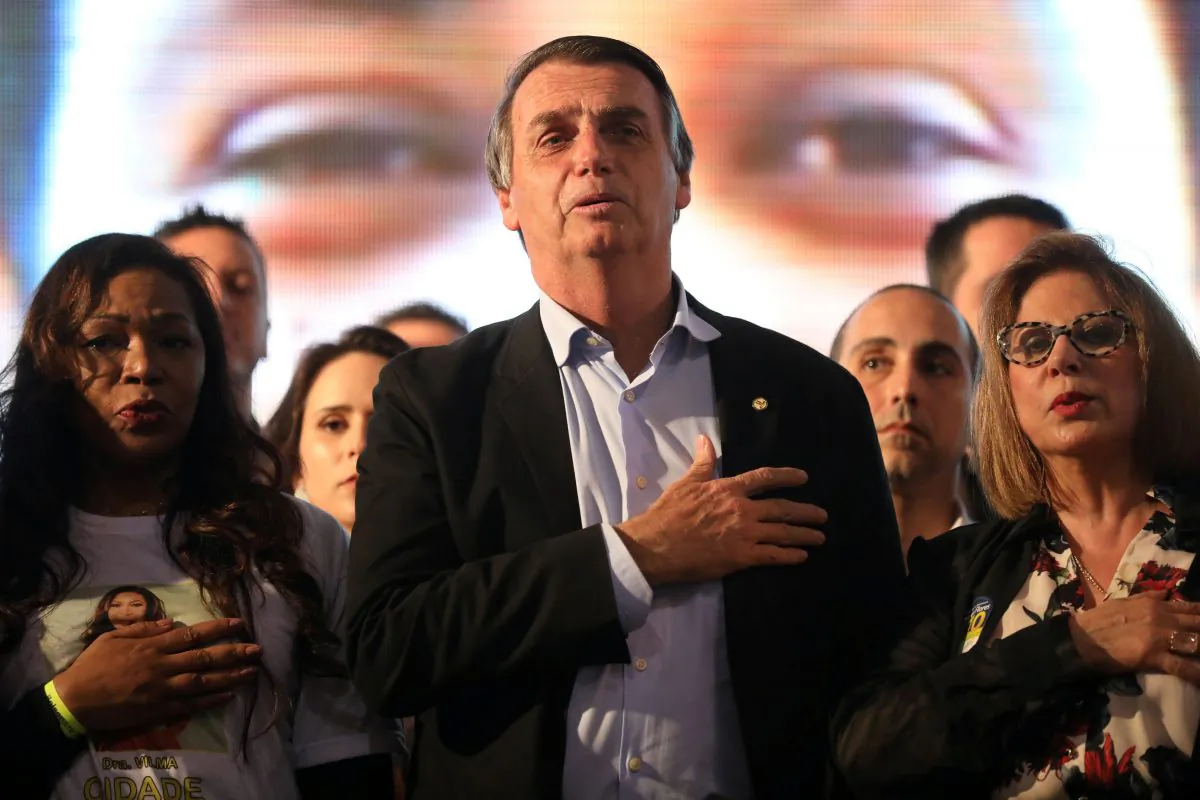 Presidential candidate Jair Bolsonaro listens to the national anthem during a meeting with women in Porto Alegre, Brazil Aug. 30, 2018.  (By Diego Vara/Reuters)
