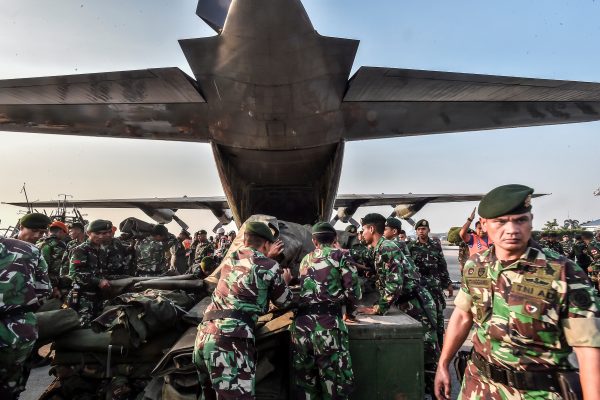 Indonesian soldiers load emergency supplies into a Hercules military plane before heading to Palu at Halim Perdanakusuma military base in Jakarta