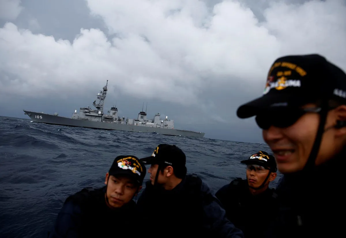 Japanese destroyer Inazuma is seen behind one of its ship inspection teams on a small patrol boat in the Indian Ocean on Sept. 27, 2018. (Kim Kyung-Hoon/Reuters)