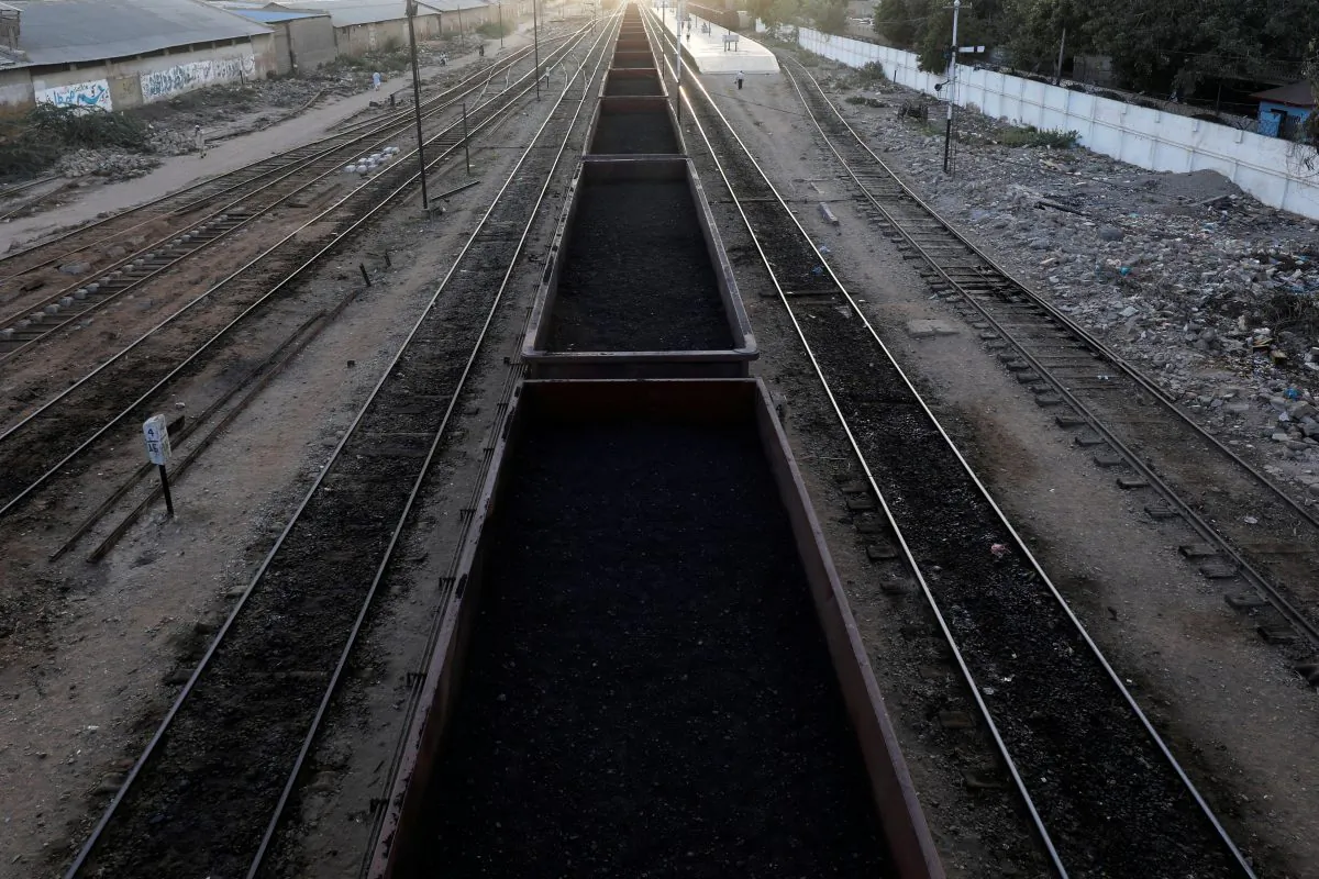 A cargo train loaded with coal dust moves past the port area near City Station in Karachi, Pakistan on Sept. 24, 2018. (Akhtar Soomro/Reuters)