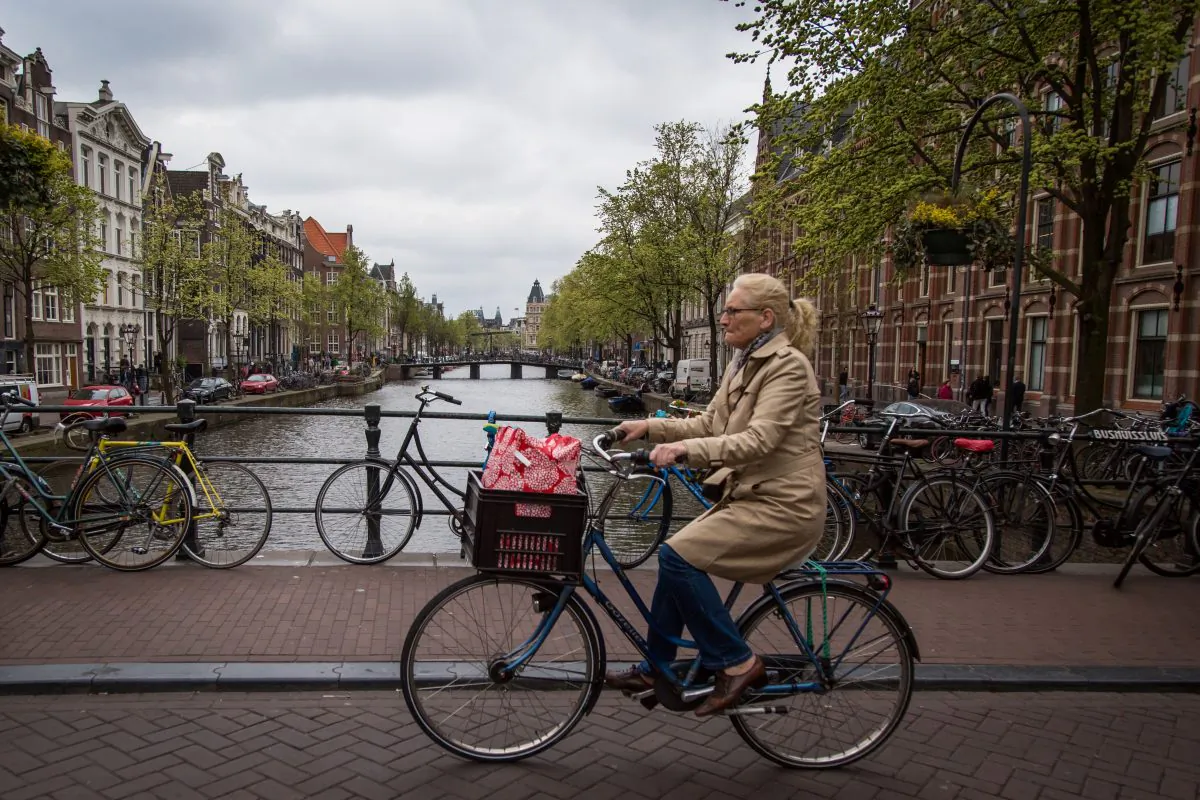 A woman rides a bicycle in Amsterdam on April 12, 2017. (Aurore Belot/AFP/Getty Images)