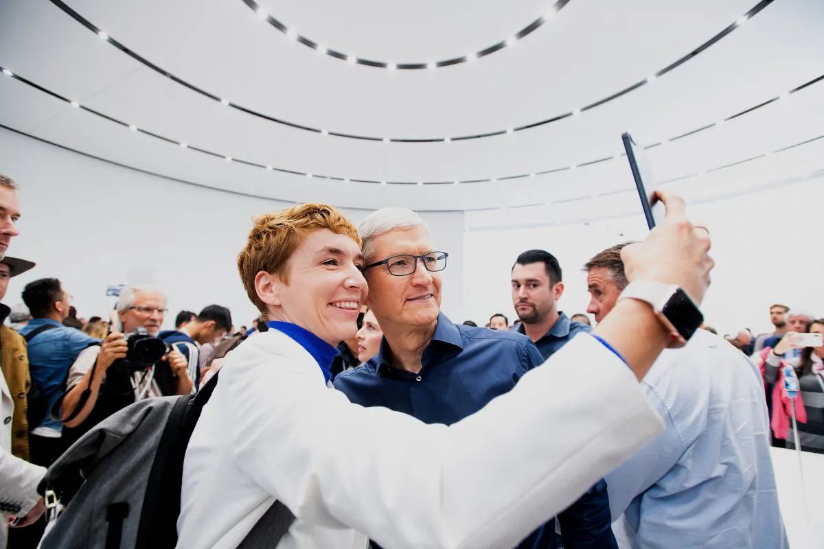 Apple CEO Tim Cook poses for a selfie with journalist Britta Weddeling during a launch event in Cupertino, California, on Sept. 12, 2018. (NOAH BERGER/AFP/Getty Images)