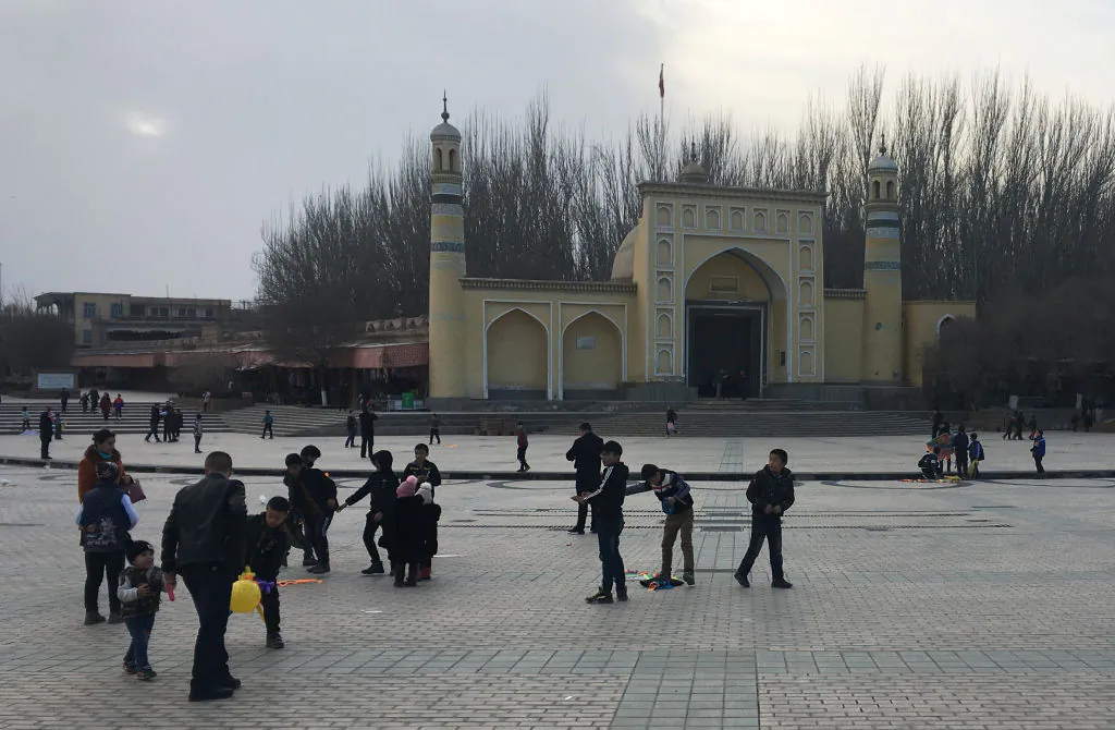 Children play outside the Id-kah mosque in Kashgar, in China's western Xinjiang region, on Feb. 18, 2018. (Ben Dooley/AFP/Getty Images)