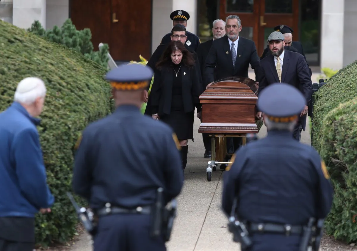 The casket of Irving Younger, 69, a victim of Saturday's synagogue shooting, is carried to a waiting hearse after his funeral at Rodef Shalom Temple in Pittsburgh, Pa, U.S., Oct. 31, 2018. (Reuters/Cathal McNaughton)