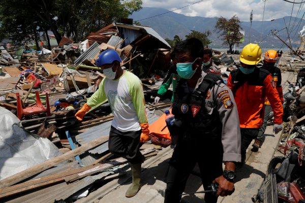 Rescuers carry a body