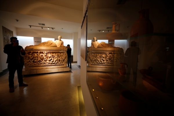 A visitor takes a picture with his mobile phone during the reopening of Syria's National Museum of Damascus