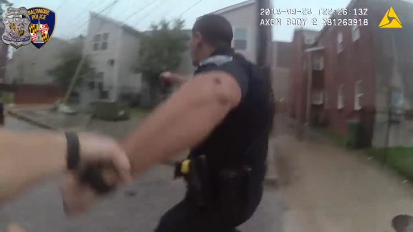 one policeman pulls another to safety