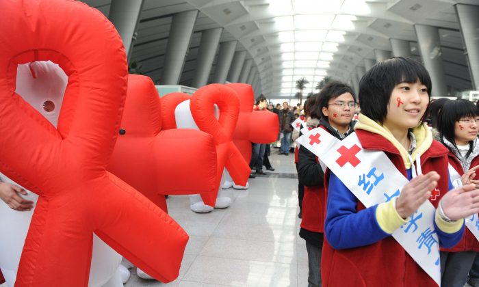 Volunteers from Red Cross China take part in an AIDS-awareness event on World AIDS Day at Beijing's south railway station on December 1, 2009, to call for better government support for HIV/AIDS victims in China. (AFP/AFP/Getty Images)