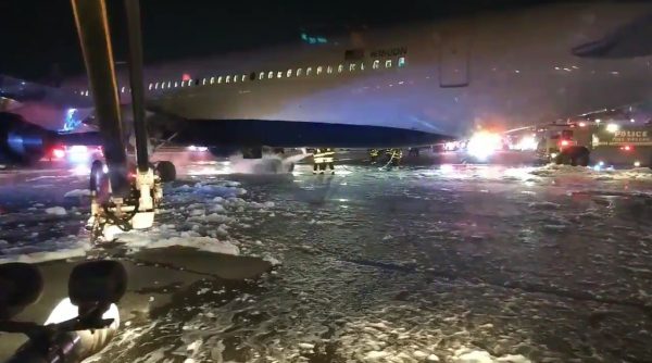 Firefighters douse the landing gear
