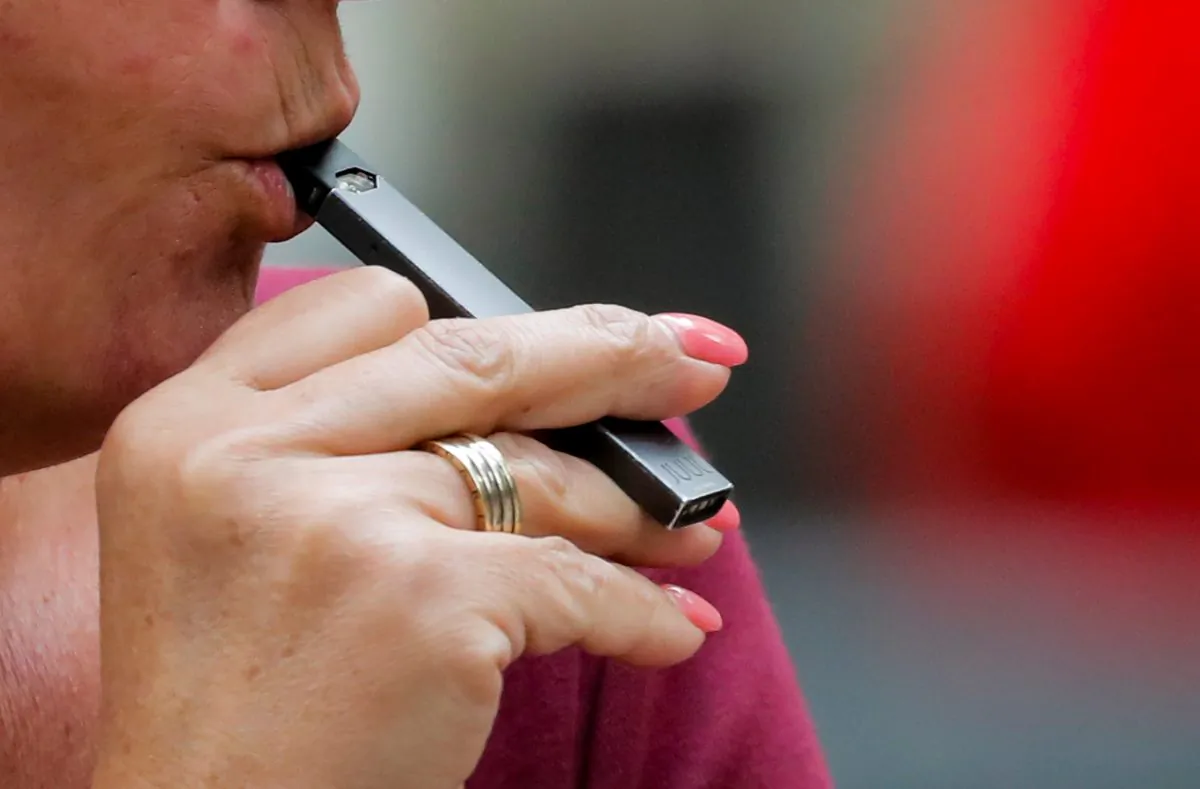 A woman smokes a Juul e-cigarette in New York on Sept. 27, 2018. (Brendan McDermid/Reuters)