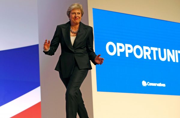 British Prime Minister Theresa May arrives on stage dancing to Abba's 'Dancing Queen'