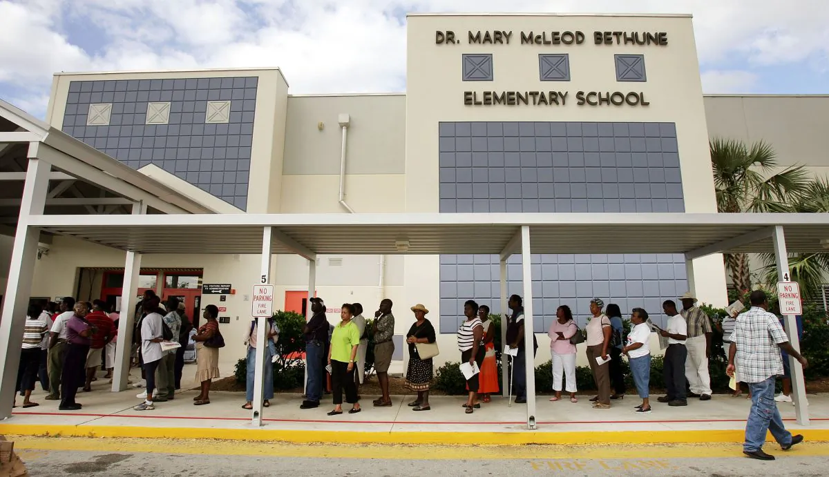 Voters wait in line to cast their ballots in Riviera Beach, Fla., on Nov. 2, 2004. (Mario Tama/Getty Images)