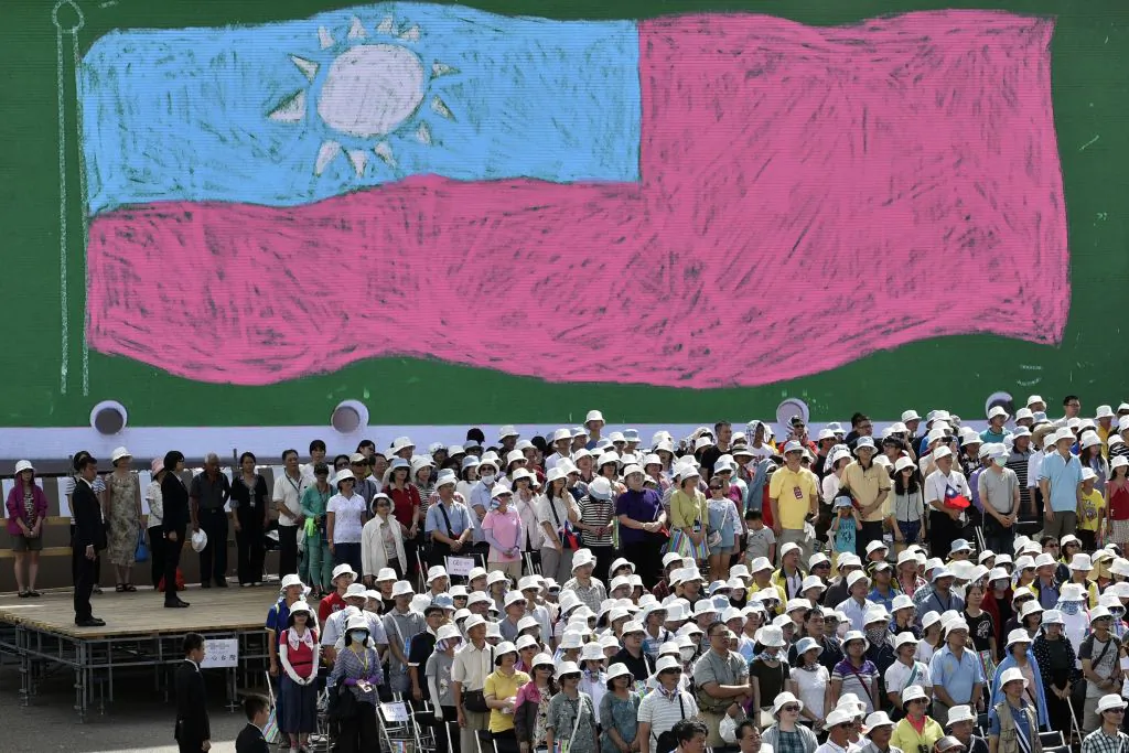 Overseas Taiwanese stand in front of a Taiwan flag while taking part in a National Day ceremony in Taipei on Oct. 10, 2017. (Sam Yeh/AFP/Getty Images)
