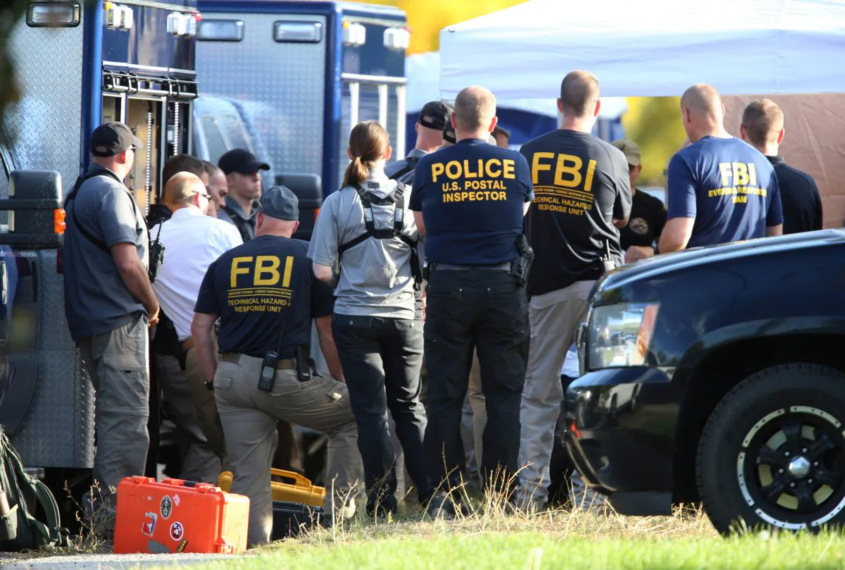 FBI and other law enforcement officers meet before entering a house that's being investigated by FBI for "potentially hazardous chemicals" in Logan, Utah, on Oct. 3, 2018. (George Frey/Reuters)