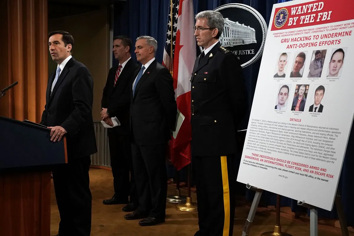 Assistant U.S. Attorney General for National Security John C. Demers (L), United States Attorney for the Western District of Pennsylvania Scott W. Brady (3rd L), FBI Deputy Assistant Director for Cyber Division Eric Welling (2nd L), and Director General Mark Flynn (R) for the Royal Canadian Mounted Police at a news conference in Washington on Oct. 4, 2018. (Alex Wong/Getty Images)