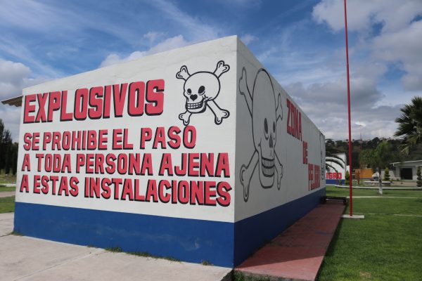 Signs warn of the dangers of fireworks at a shop in La Saucera, in Tultepec, Mexico.