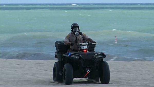 Miami-Dade police officer wearing a gas mask