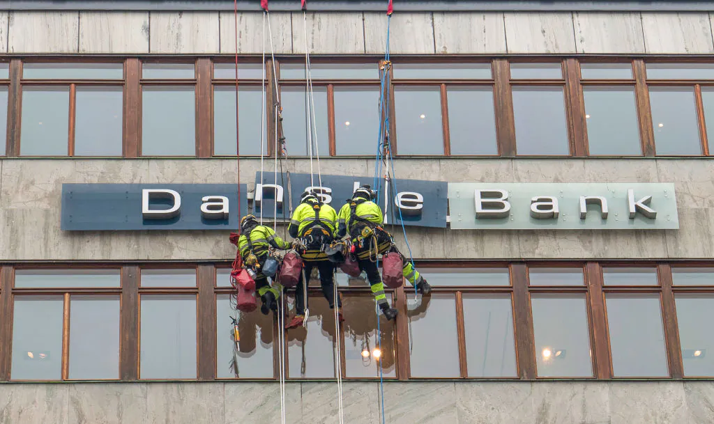 Workers maintaining the Danske Bank sign in central Stockholm, Sweden in this file photo. (Leif Blom/AFP/Getty Images)