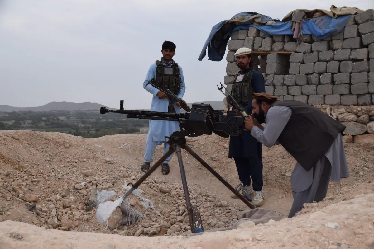Members of an armed pro-government uprising group in an outpost just outside of Kaga, the center of the district of Khogyani in the eastern Afghan province of Nangarhar, with Malek Gul Shirin, the commander of the group, manning a heavy machine gun, on Oct. 2, 2018. (Franz J. Marty/Special to The Epoch Times)