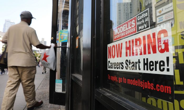 A now hiring sign in the window of a Brooklyn business in New York on Oct. 5, 2018. (Spencer Platt/Getty Images)