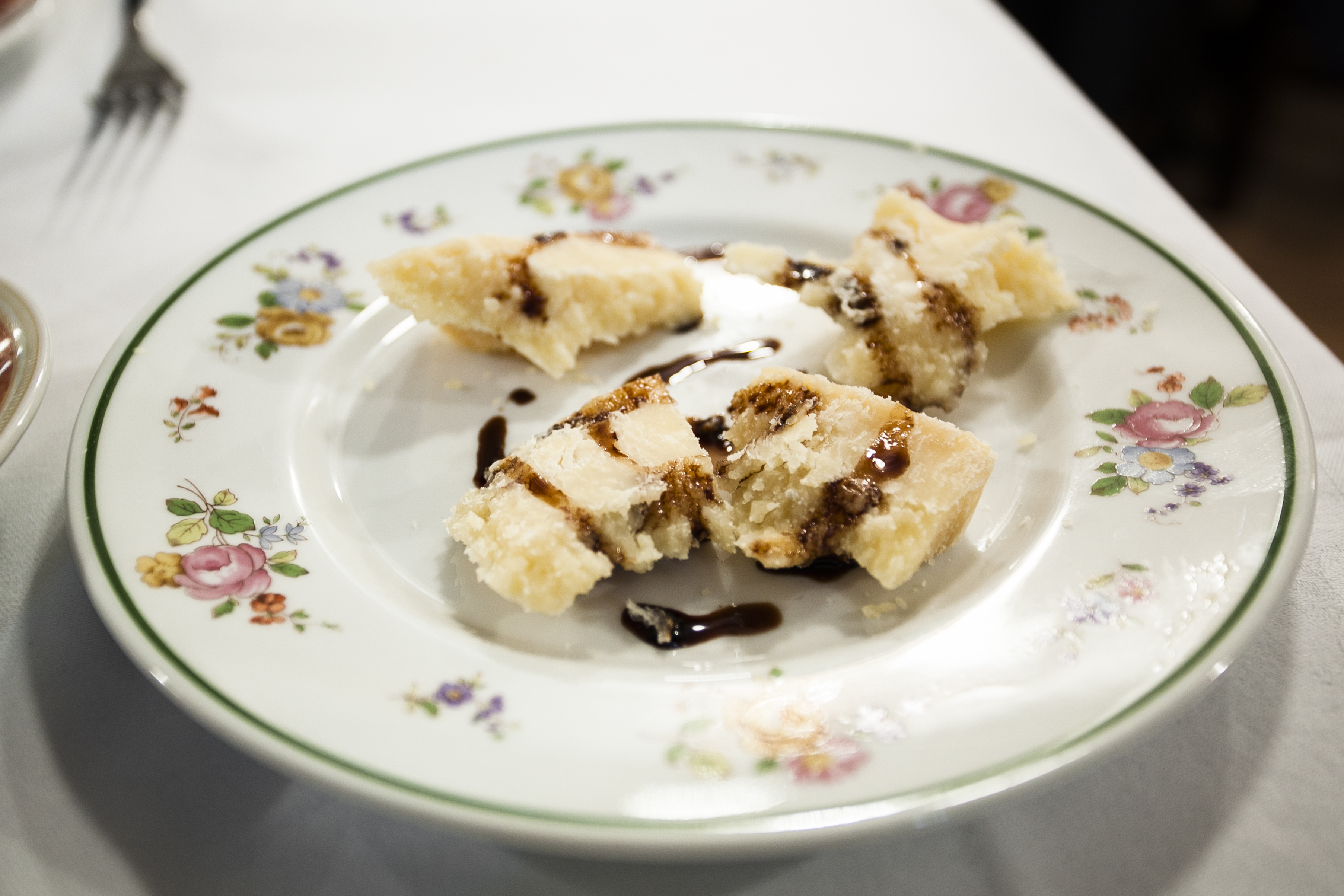 plate of parmigiano reggiano cheese and balsamic vinegar