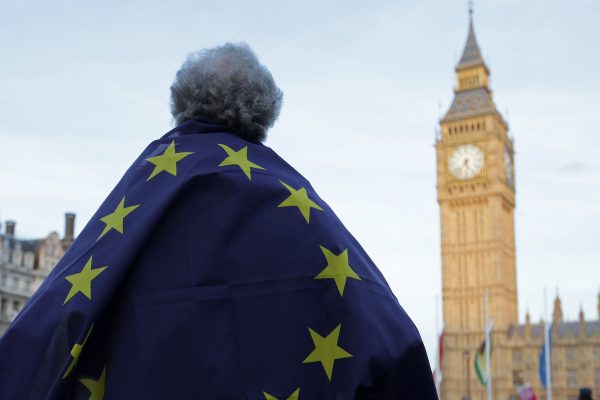 A protester draped in a European Union flag outside the Houses of Parliament
